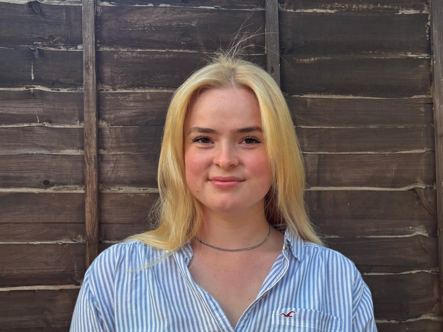 Francesca standing next to a fence.