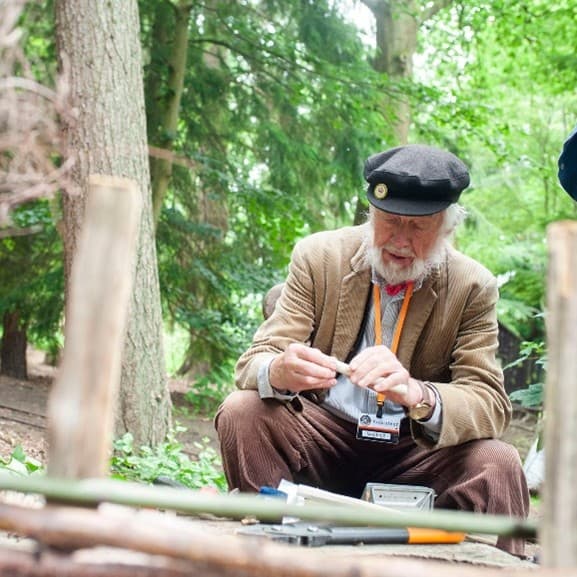 A volunteer outside using a pen.