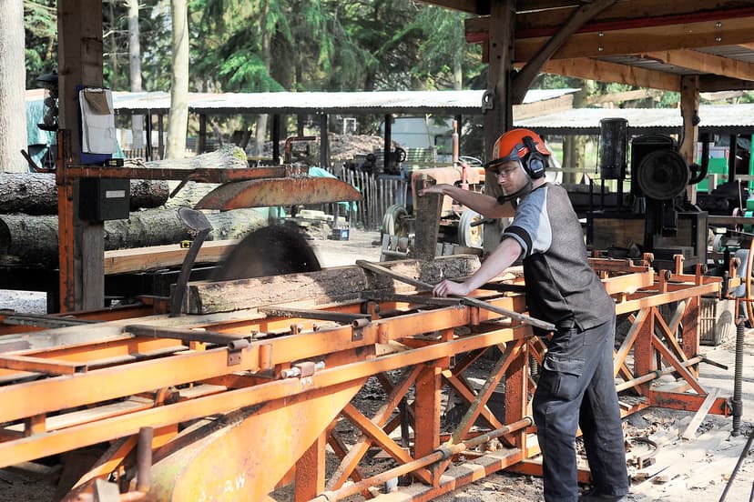 A volunteer using a saw in the Woodyard at the Rural Life Living Museum