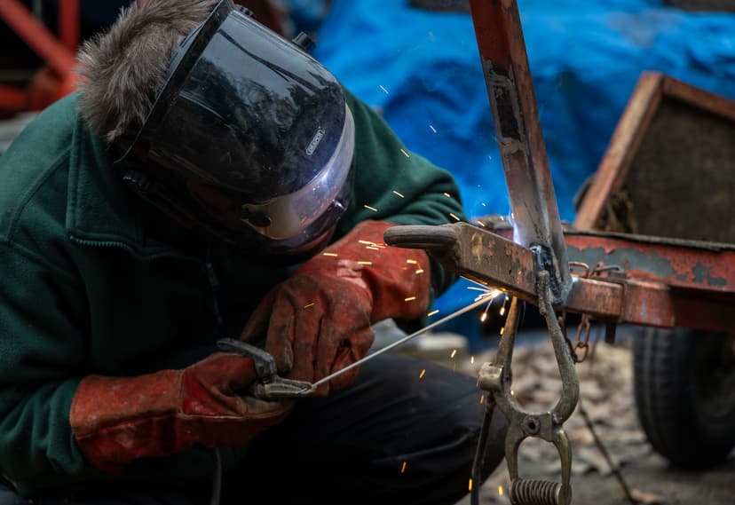 A volunteer welding a piece of machinery at the Rural Life Living Museum