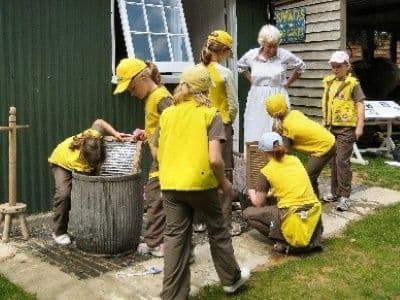 Picture of children washing clothes with washboards.